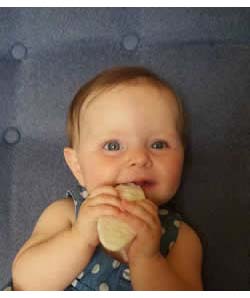 Happy Baby eating Rice Rusk