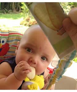 Happy Baby eating Rice Rusk