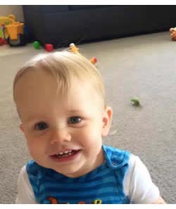 Happy Baby eating Rice Rusk