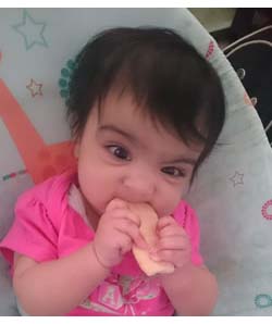 Happy Baby eating Rice Rusk